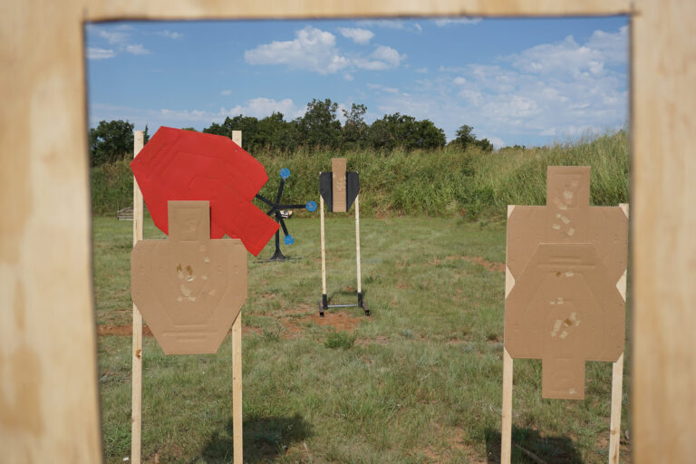 Cardboard scoring targets and a red no-shoot target set up on a PCSL match stage.