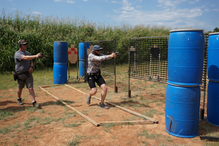 A range officer follows a competitor through a stage of the PCSL pistol match.