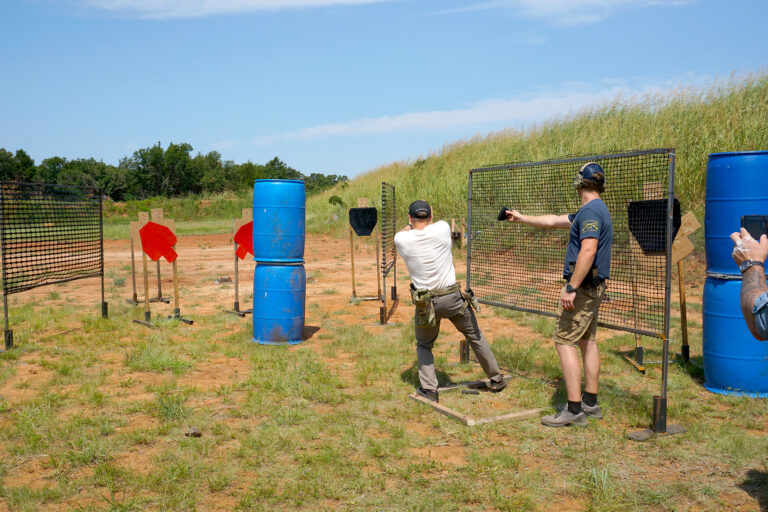 Competitors and officials on a stage during the PCSL pistol match.